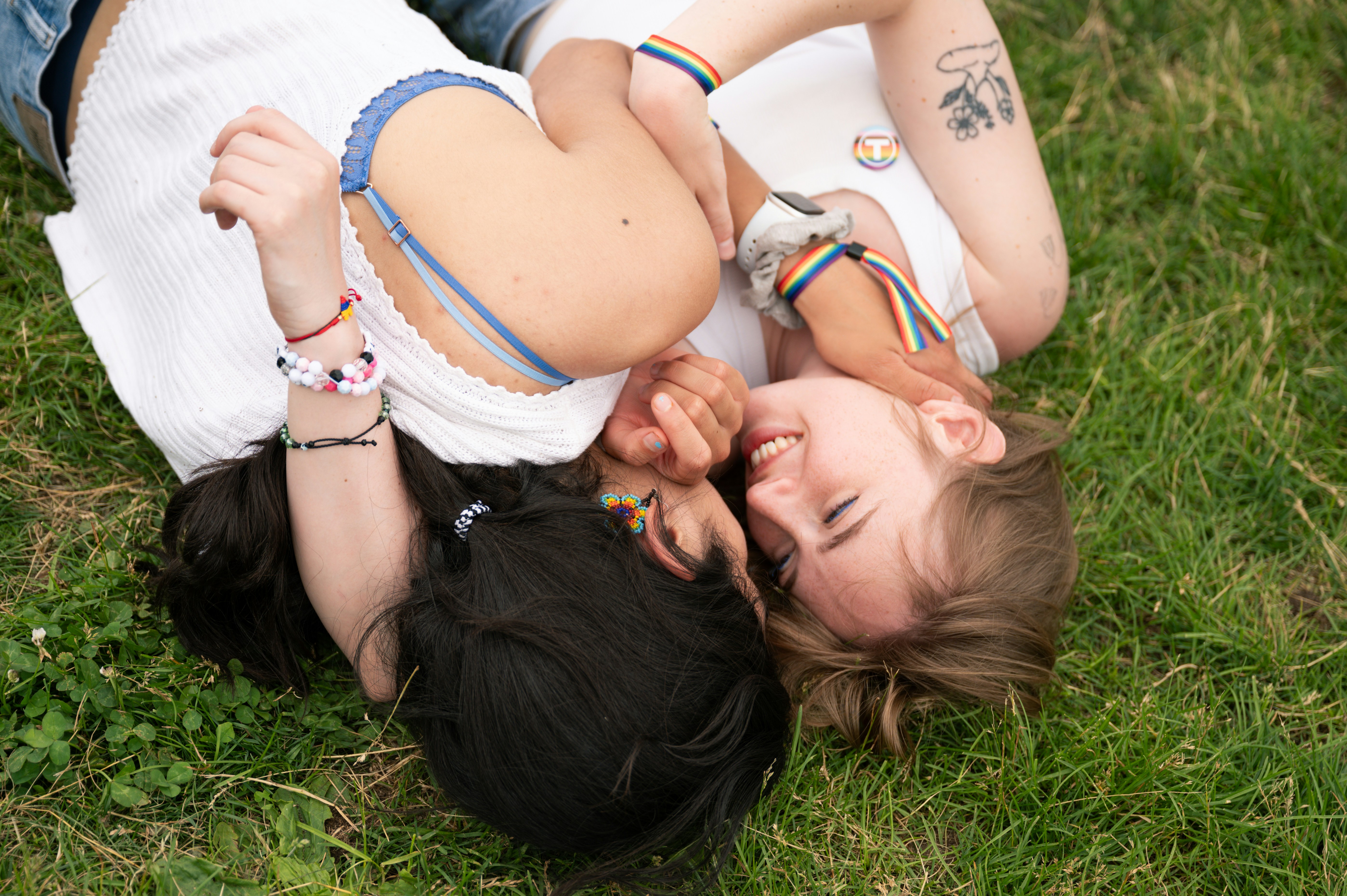 Two young women lying on grass, smiling
